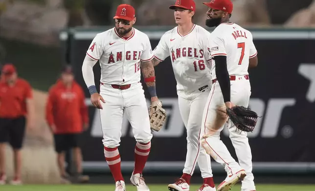 Los Angeles Angels left fielder Kevin Pillar, center fielder Mickey Moniak, and right fielder Jo Adell celebrate the team's win in a baseball game against the Detroit Tigers, Friday, June 28, 2024, in Anaheim, Calif. (AP Photo/Ryan Sun)