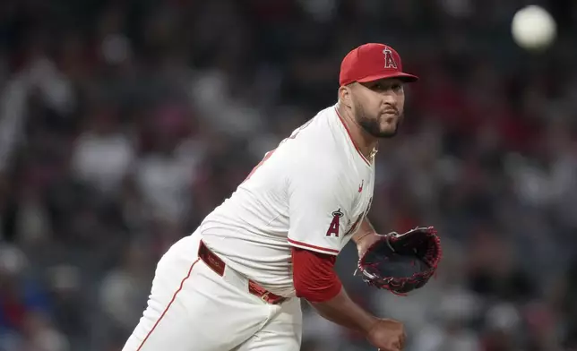 Los Angeles Angels relief pitcher Carlos Estevez tries to pick off Detroit Tigers' Wenceel Perez at first base during the ninth inning of a baseball game in Anaheim, Calif., Saturday, June 29, 2024. (AP Photo/Eric Thayer)