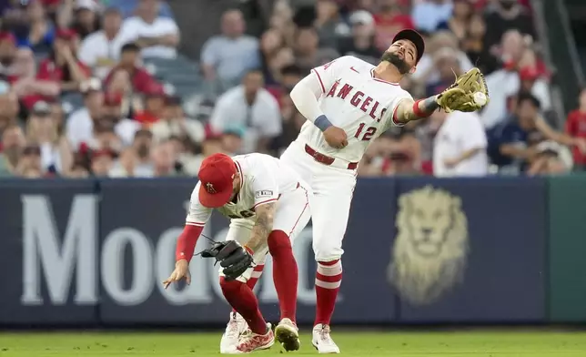Los Angeles Angels left fielder Kevin Pillar, right, collides with shortstop Zach Neto while catching a fly ball hit by Detroit Tigers' Mark Canha during the sixth inning of a baseball game, Friday, June 28, 2024, in Anaheim, Calif. (AP Photo/Ryan Sun)