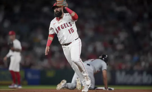 Los Angeles Angels second baseman Luis Guillorme (15) holds up the ball after tagging out Detroit Tigers' Riley Greene on a steal attempt during the ninth inning of a baseball game in Anaheim, Calif., Saturday, June 29, 2024. (AP Photo/Eric Thayer)