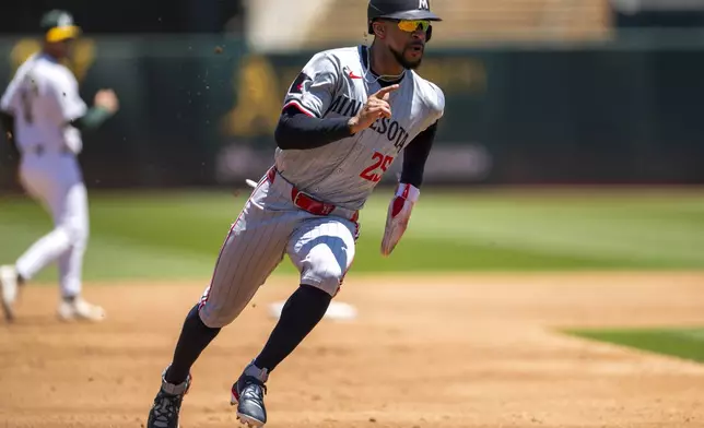 Minnesota Twins' Byron Buxton (25) runs to third during the second inning of a baseball game against the Oakland Athletics in Oakland, Calif,. Saturday, June 22, 2024. (AP Photo/Nic Coury)