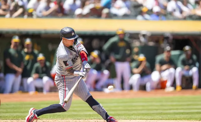 Minnesota Twins' Jose Miranda hits a single during the fifth inning of a baseball game against the Oakland Athletics in Oakland, Calif,. Saturday, June 22, 2024. (AP Photo/Nic Coury)