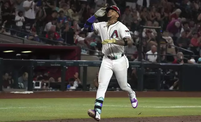 Arizona Diamondbacks' Ketel Marte reacts after hitting a solo home run against the Minnesota Twins in the fourth inning during a baseball game, Thursday, June 27, 2024, in Phoenix. (AP Photo/Rick Scuteri)