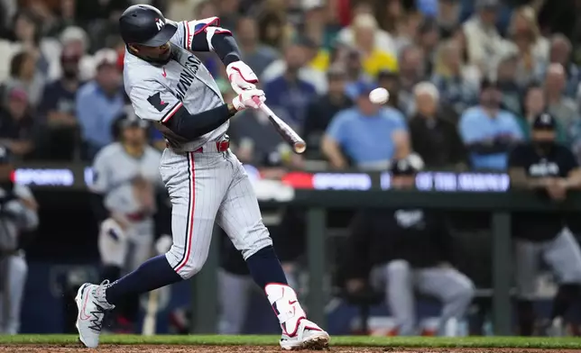 Minnesota Twins' Byron Buxton hits a three-run home run to score Carlos Correa and Jose Miranda against the Seattle Mariners during the sixth inning of a baseball game Saturday, June 29, 2024, in Seattle. (AP Photo/Lindsey Wasson)