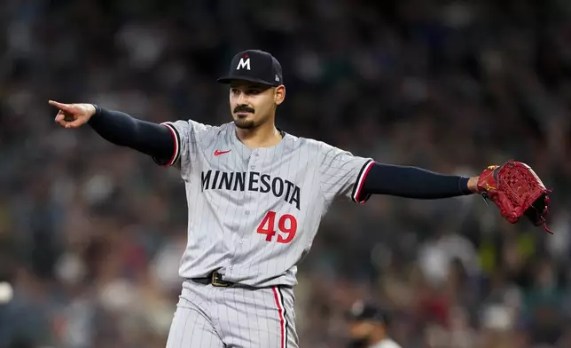 Minnesota Twins starting pitcher Pablo López points after Seattle Mariners' Ty France grounded into a double play during the second inning of a baseball game Saturday, June 29, 2024, in Seattle. (AP Photo/Lindsey Wasson)