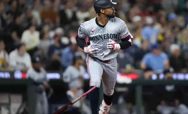 Minnesota Twins' Byron Buxton flips his bat after hitting a three-run home run against the Seattle Mariners during the sixth inning of a baseball game Saturday, June 29, 2024, in Seattle. (AP Photo/Lindsey Wasson)