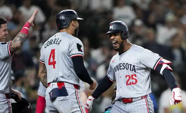 Minnesota Twins' Byron Buxton (25) greets teammates Jose Miranda, left, and Carlos Correa, center, who scored on his three-run home run against the Seattle Mariners during the sixth inning of a baseball game Saturday, June 29, 2024, in Seattle. (AP Photo/Lindsey Wasson)