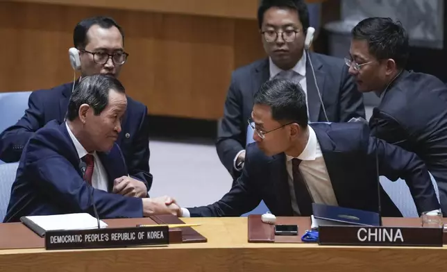 Chinese deputy ambassador to the United Nations Geng Shuang, right, shakes hands with North Korean ambassador to the UN Song Kim at the end of a Security Council meeting at United Nations headquarters, Friday, June 28, 2024. (AP Photo/Seth Wenig)