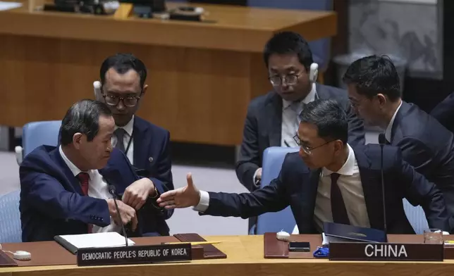 Chinese deputy ambassador to the United Nations Geng Shuang, right, offers his hand to North Korean ambassador to the UN Song Kim at the end of a Security Council meeting at United Nations headquarters, Friday, June 28, 2024. (AP Photo/Seth Wenig)