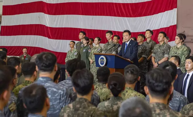 In this photo provided by U.S. Navy, South Korean President Yoon Suk Yeol gives remarks aboard the Nimitz-class aircraft carrier USS Theodore Roosevelt (CVN 71) in Busan, South Korea, Tuesday, June 25, 2024. The newly-inaugurated Freedom Edge exercise is wrapping up in the East China Sea, having brought together Japanese, South Korean and American naval assets for multi-domain maneuvers for the first time. (Mass Communication Specialist Seaman Aaron Haro Gonzalez/U.S. Navy via AP)
