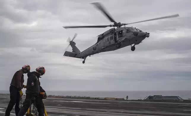 In this handout photo provided by the U.S. Navy, MH-60S Sea Hawk, assigned to the "Eightballers" of Helicopter Sea Combat Squadron (HSC) 8, lands on the flight deck of the Nimitz-class aircraft carrier USS Theodore Roosevelt (CVN 71) during exercise Freedom Edge, on Friday, June 28, 2024. The newly-inaugurated Freedom Edge exercise is wrapping up in the East China Sea, having brought together Japanese, South Korean and American naval assets for multi-domain maneuvers for the first time. (Mass Communication Specialist Seaman Aaron Haro Gonzalez/U.S. Navy via AP)
