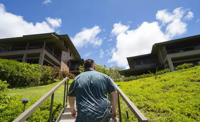 Jeremy Stice, who manages more than 40 vacation rental properties, walks around The Ridge Villas on Monday, June 24, 2024, in Lahaina, Hawaii. The Ridge Villas with 142 units for short-term rental is part of the 101 properties that the County of Maui may begin phasing out as early as 2025. (AP Photo/Mengshin Lin)