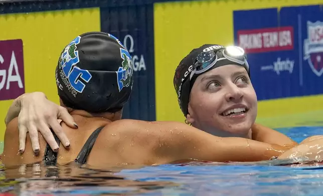 Kate Douglass and Torri Huske embrace after the Women's 100 freestyle finals Wednesday, June 19, 2024, at the US Swimming Olympic Trials in Indianapolis. (AP Photo/Michael Conroy)