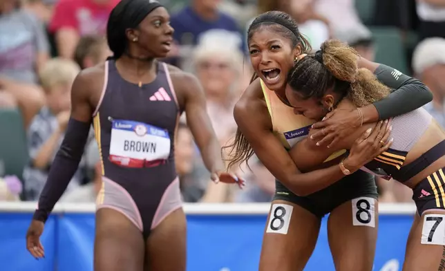 Gabby Thomas celebrates after winning the women's 200-meter final with third place winner McKenzie Long during the U.S. Track and Field Olympic Team Trials Saturday, June 29, 2024, in Eugene, Ore. (AP Photo/George Walker IV)
