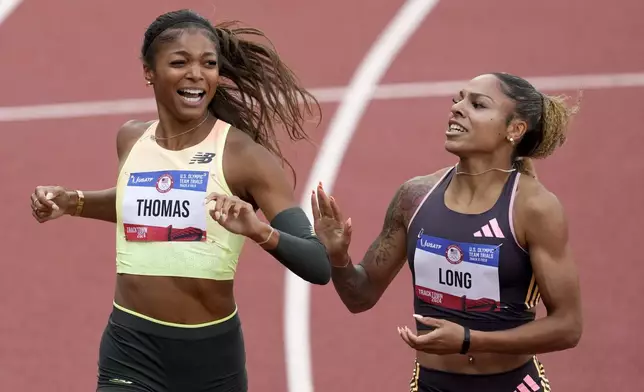 Gabby Thomas celebrates after winning the women's 200-meter final with third place winner McKenzie Long during the U.S. Track and Field Olympic Team Trials Saturday, June 29, 2024, in Eugene, Ore. (AP Photo/Chris Carlson)