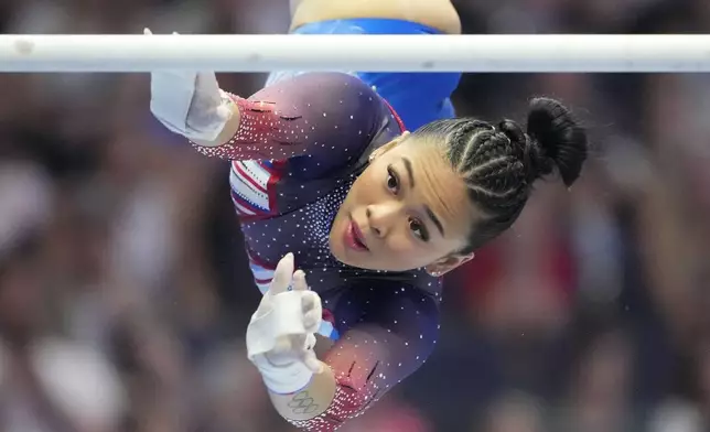 Suni Lee competes on the uneven bars at the United States Gymnastics Olympic Trials on Friday, June 28, 2024, in Minneapolis. (AP Photo/Charlie Riedel)