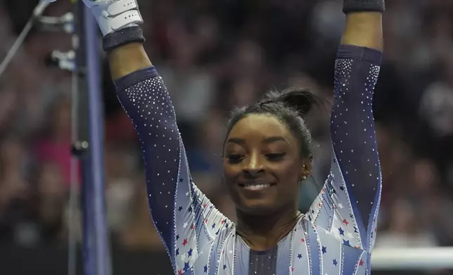 Simone Biles lands after the uneven bars at the United States Gymnastics Olympic Trials on Friday, June 28, 2024 in Minneapolis. (AP Photo/Abbie Parr)