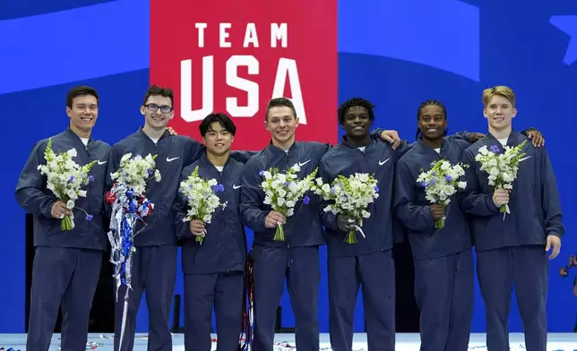 From left to right, Brody Malone, Stephen Nedoroscik, Asher Hong, Paul Juda, Frederick Richard, Khoi Young and Shane Wiskus celebrate after being named to the 2024 Olympic team at the United States Gymnastics Olympic Trials on Saturday, June 29, 2024, in Minneapolis. (AP Photo/Charlie Riedel)
