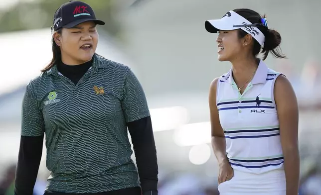 Andrea Lee, right, walks with Wichanee Meechai, of Thailand, after the two finished the day in a 3-way tie for first during the third round of the U.S. Women's Open golf tournament at Lancaster Country Club, Saturday, June 1, 2024, in Lancaster, Pa. (AP Photo/Matt Rourke)