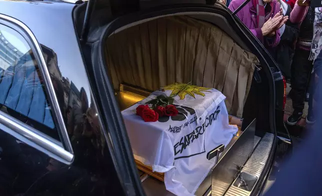 The coffin that contains the remains of Amelia Sanjurjo sits inside a hearse during her funeral service at the University of the Republic, in Montevideo, Uruguay, Thursday, June 6, 2024. The Uruguayan Prosecutor’s Office confirmed that the human remains found in June 2023 at the 14th Battalion of the Uruguayan Army belong to Sanjurjo, a victim of the 1973-1985 dictatorship who was 41 years old and pregnant at the time of her disappearance. (AP Photo/Matilde Campodonico)
