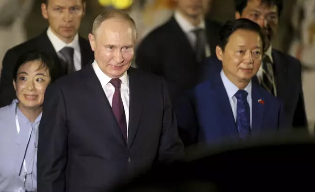 Russian President Vladimir Putin, left, and Vietnamese Deputy Prime Minister Tran Hong Ha walk together after Putin's arrival at the Noi Bai International Airport in Hanoi, Vietnam, Thursday, June. 20, 2024. (AP Photo/Minh Hoang)
