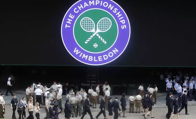 FILE - Stewards prepare for the start of the Wimbledon Tennis Championships in London, Sunday, June 30, 2019. This year's Wimbledon tournament begins on Monday, July 1.(AP Photo/Kirsty Wigglesworth, File)