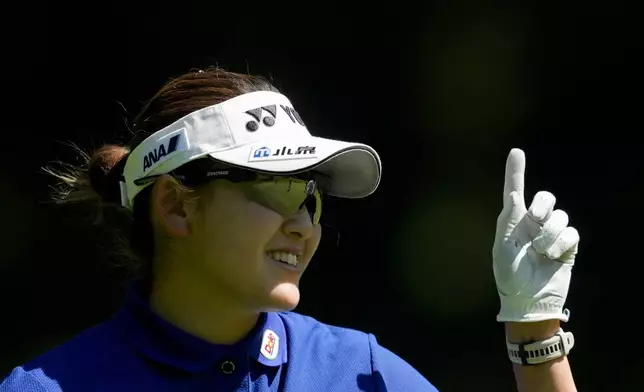 Chisato Iwai, of Japan, smiles while working on the green of the 16th hole during a practice round for the Women's PGA Championship golf tournament at Sahalee Country Club, Wednesday, June 19, 2024, in Sammamish, Wash. (AP Photo/Lindsey Wasson)