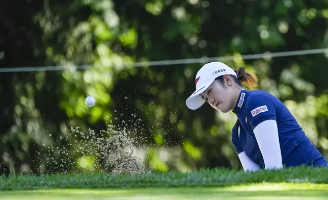 Mone Inami, of Japan, hits out of the bunker on the fourth hole during a practice round for the Women's PGA Championship golf tournament at Sahalee Country Club, Wednesday, June 19, 2024, in Sammamish, Wash. (AP Photo/Gerald Herbert)