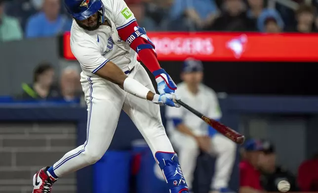 Toronto Blue Jays' Vladimir Guerrero Jr. hits a three-run double in the sixth inning of a baseball game against the New York Yankees, Saturday, June 29, 2024, in Toronto. (Frank Gunn/The Canadian Press via AP)