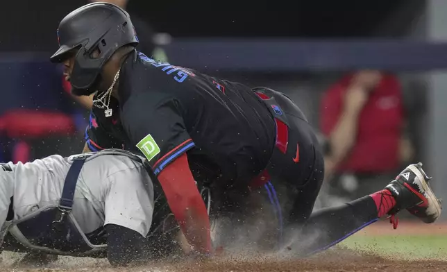 Toronto Blue Jays' Vladimir Guerrero Jr. is tagged out at home by New York Yankees catcher Jose Trevino during the fifth inning of a baseball game Friday, June 28, 2024, in Toronto. (Chris Young/The Canadian Press via AP)