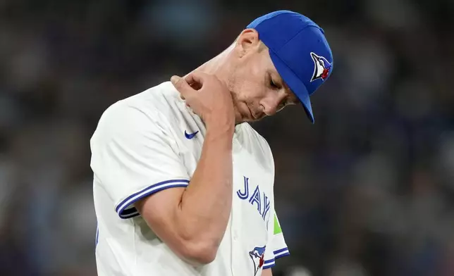 Toronto Blue Jays pitcher Chris Bassitt (40) examines a mark on his arm where a line drive off the bat of New York Yankees' Aaron Judge hit him during the first inning of a baseball game in Toronto, Saturday, June 29, 2024. (Frank Gunn/The Canadian Press via AP)