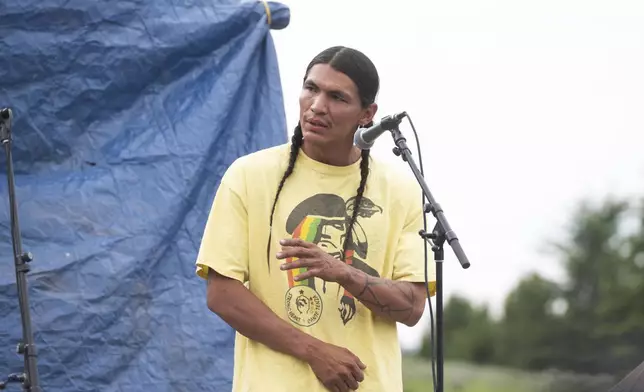 Devin Oldman, a member of the Northern Arapahoe tribe, speaks during a naming ceremony for a white buffalo calf at the headquarters of the Buffalo Field Campaign in West Yellowstone, Mont., Wednesday, June 26, 2024. The reported birth of the calf in Yellowstone National Park fulfills a Lakota prophecy that portends better times. (AP Photo/Sam Wilson)