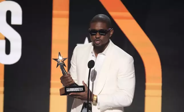 Usher accepts the award for best male R&amp;B/pop artist during the BET Awards on Sunday, June 30, 2024, at the Peacock Theater in Los Angeles. (AP Photo/Chris Pizzello)