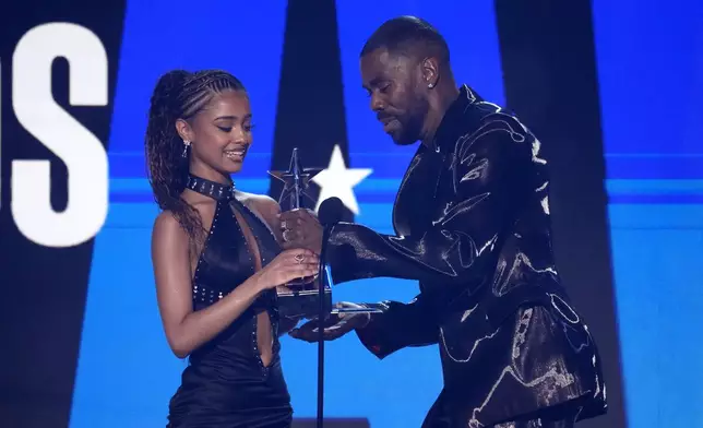 Tyla, left, accepts the award for best international act from Colman Domingo during the BET Awards on Sunday, June 30, 2024, at the Peacock Theater in Los Angeles. (AP Photo/Chris Pizzello)