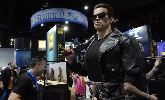 A life-size model of actor Arnold Schwarzenegger in his role as "The Terminator" is featured on the convention floor during preview night for Comic-Con International, Wednesday, July 24, 2024, in San Diego. (AP Photo/Chris Pizzello)