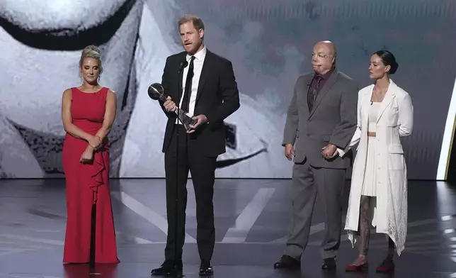 Prince Harry speaks after receiving the Pat Tillman Award For Service at the ESPY awards on Thursday, July 11, 2024, at the Dolby Theatre in Los Angeles. Looking on are Kirstie Ennis, Israel Del Toro, and Elizabeth Marks, right. (AP Photo/Mark J. Terrill)