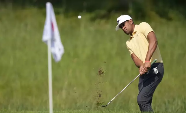 Tony Finau chips on the third green during the first round of the 3M Open golf tournament at the Tournament Players Club, Thursday, July 25, 2024, in Blaine, Minn. (AP Photo/Charlie Neibergall)