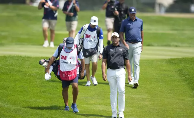 Jhonattan Vegas walks on the fairway on the seventh hole during the final round of the 3M Open golf tournament at the Tournament Players Club, Sunday, July 28, 2024, in Blaine, Minn. (AP Photo/Charlie Neibergall)