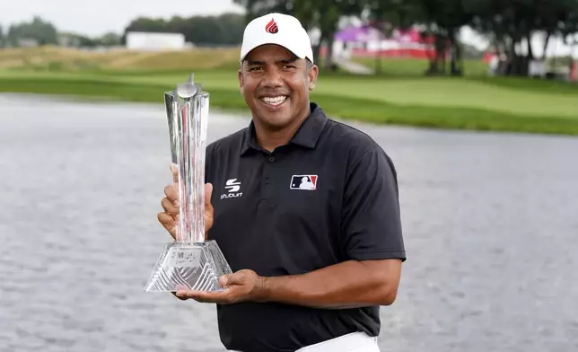 Jhonattan Vegas holds the trophy after winning the 3M Open golf tournament at the Tournament Players Club, Sunday, July 28, 2024, in Blaine, Minn. (AP Photo/Charlie Neibergall)