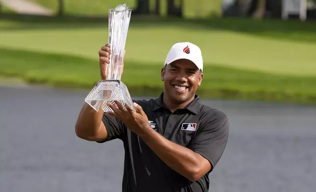 Jhonattan Vegas holds the trophy after winning the 3M Open golf tournament at the Tournament Players Club, Sunday, July 28, 2024, in Blaine, Minn. (AP Photo/Charlie Neibergall)