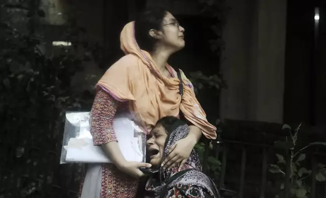 Sanjida, left, consoles her mother as she breaks into tears after receiving the dead body of her son, who was shot during a clash between the police and anti-quota protesters, at a morgue in Dhaka, Bangladesh, Monday, July 22, 2024. Internet and mobile data services are still down despite apparent calm in Bangladesh following a verdict that scaled back a controversial quota system for government jobs after weeks of relentless protests that turned deadly. (AP Photo/Anik Rahman)