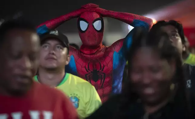 A soccer fan dressed as Spiderman reacts watches Brazil play Uruguay in a Copa America quarterfinal match on a screen set up for fans on Copacabana Beach in Rio de Janeiro, Sunday, July 7, 2024. Brazil lost in a penalty shootout and Uruguay qualified for the semifinals. (AP Photo/Bruna Prado)