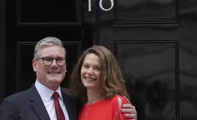 Britain's Labour Party Prime Minister Keir Starmer and his wife Victoria pose for the media on the doorstep of 10 Downing Street in London, Friday, July 5, 2024. Labour leader Starmer won the general election on July 4, and was appointed Prime Minster by King Charles III at Buckingham Palace, after the party won a landslide victory. (AP Photo/Kin Cheung)