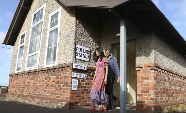 Britain's Prime Minister Rishi Sunak and his wife Akshata Murty leave a polling station after voting near Richmond, North Yorkshire, England, Thursday, July 4, 2024. Britain goes to the polls Thursday after Prime Minister Rishi Sunak called a general election. (AP Photo/Scott Heppell )