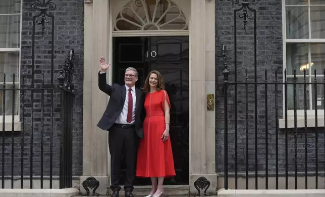 Britain's Labour Party Prime Minister Keir Starmer and his wife Victoria waves to the crowds of supporters and media from the doorstep of 10 Downing Street in London, Friday, July 5, 2024. Labour leader Starmer won the general election on July 4, and was appointed Prime Minster by King Charles III at Buckingham Palace, after the party won a landslide victory. (AP Photo/Kin Cheung)