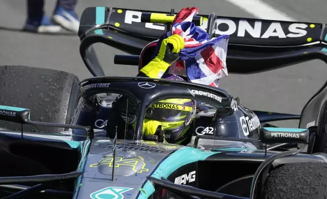 Mercedes driver Lewis Hamilton of Britain celebrates after winning the British Formula One Grand Prix race at the Silverstone racetrack, Silverstone, England, Sunday, July 7, 2024. (AP Photo/Luca Bruno)