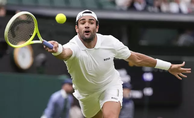 Matteo Berrettini of Italy plays a forehand return to compatriot Jannik Sinner during their match on day three at the Wimbledon tennis championships in London, Wednesday, July 3, 2024. (AP Photo/Alberto Pezzali)