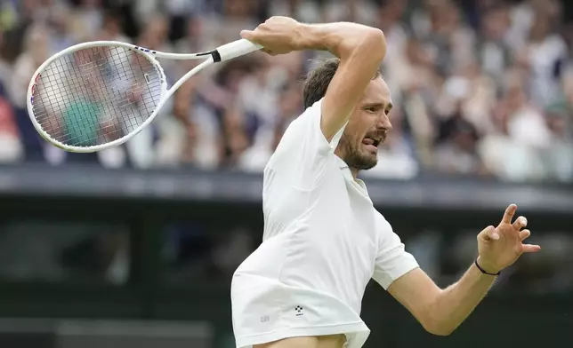 Daniil Medvedev of Russia plays a forehand return to Jannik Sinner of Italy during their quarterfinal match at the Wimbledon tennis championships in London, Tuesday, July 9, 2024. (AP Photo/Alberto Pezzali)