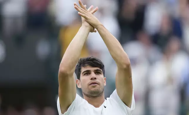 Carlos Alcaraz of Spain celebrates after defeating Aleksandar Vukic of Australia during their match on day three at the Wimbledon tennis championships in London, Wednesday, July 3, 2024. (AP Photo/Mosa'ab Elshamy)