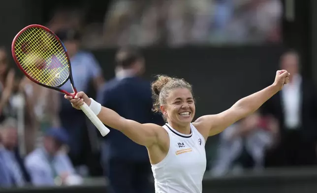 Jasmine Paolini of Italy celebrates after defeating Donna Vekic of Croatia in their semifinal match at the Wimbledon tennis championships in London, Thursday, July 11, 2024. (AP Photo/Mosa'ab Elshamy)